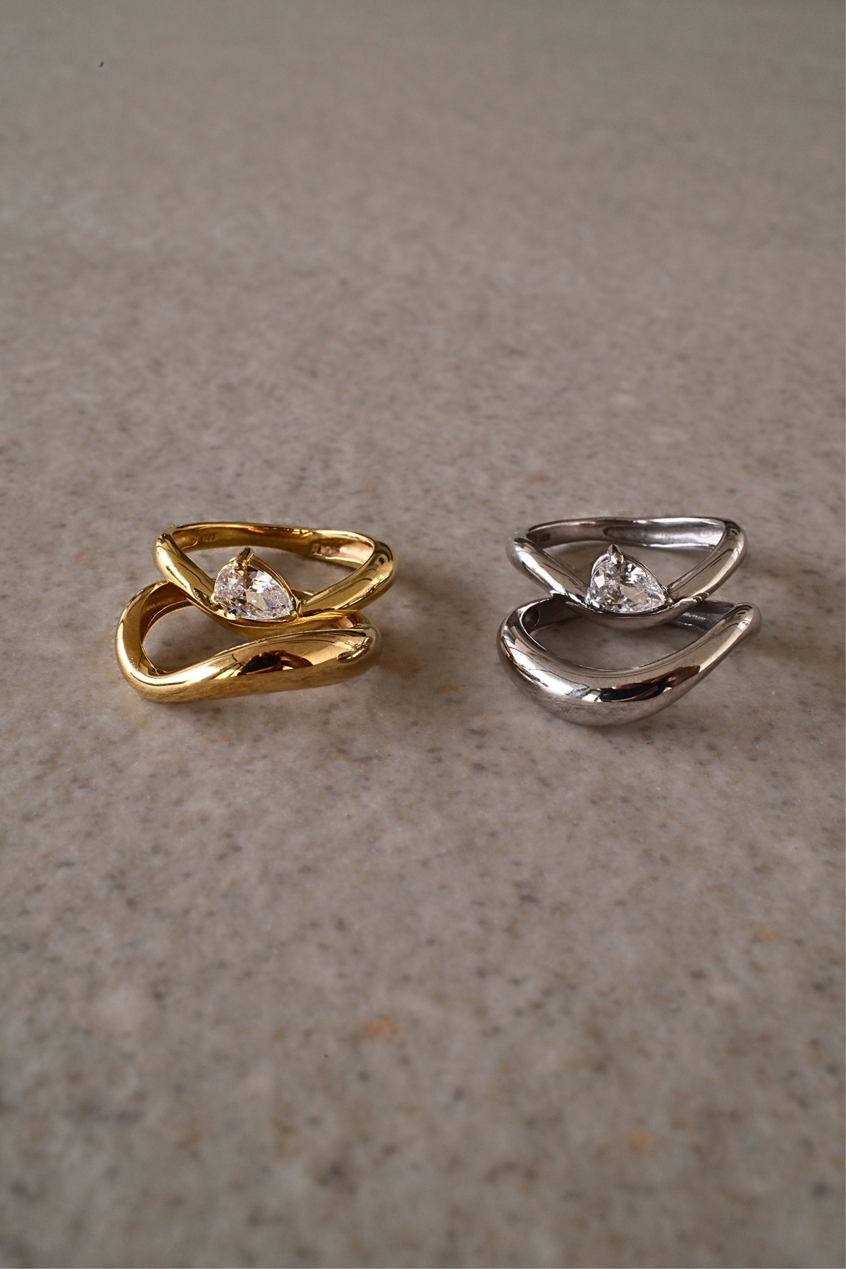 Gold vermeil and silver duet ring sets displayed side by side