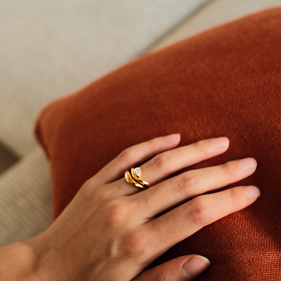 Close-up of gold vermeil duet Ring with pear-cut stone and curved band