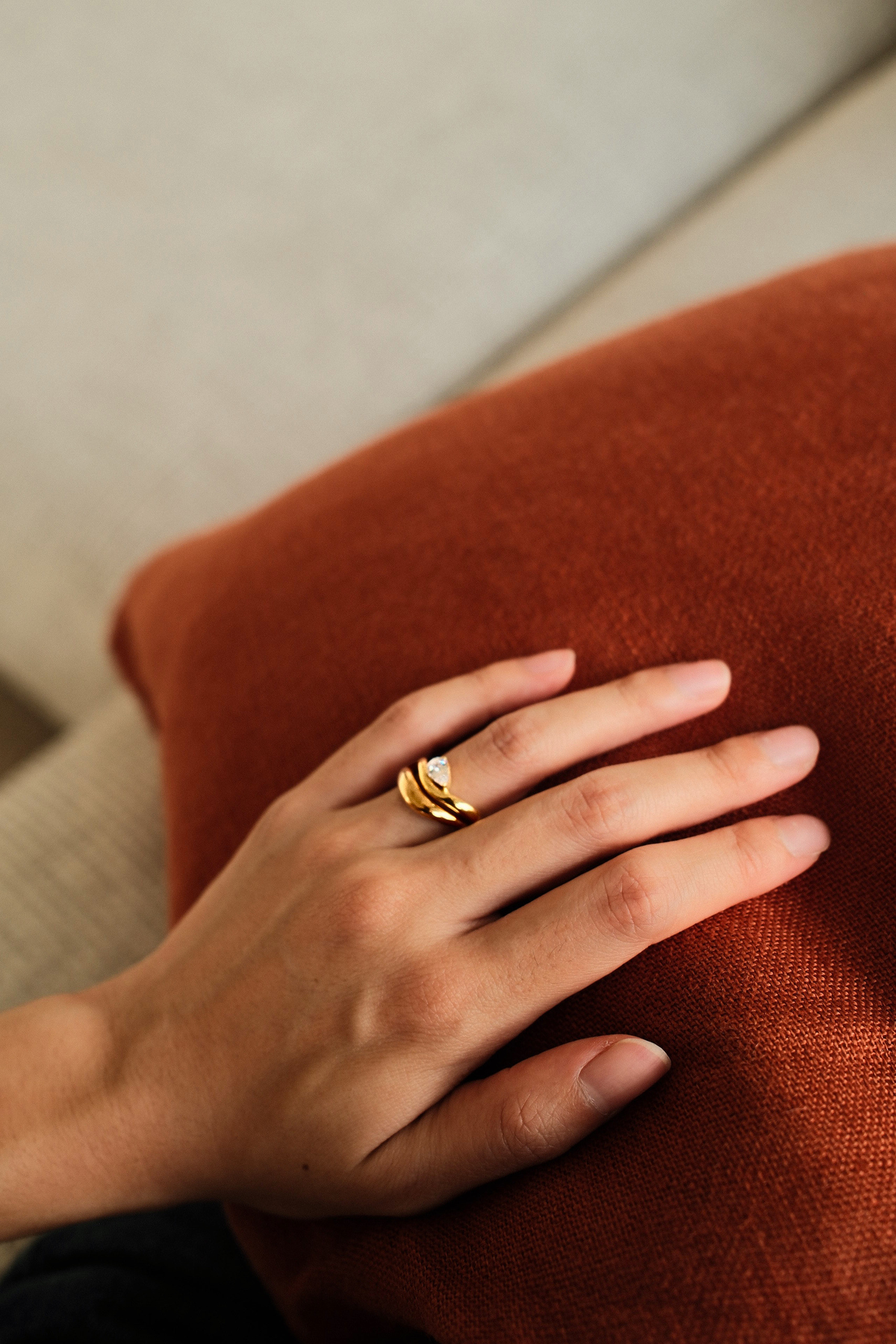 Close-up of gold vermeil duet Ring with pear-cut stone and curved band
