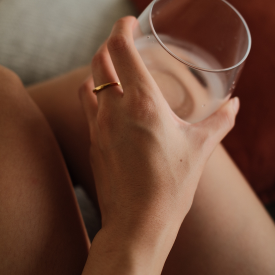 Close-up of gold vermeil duet Ring with pear-cut stone and curved band